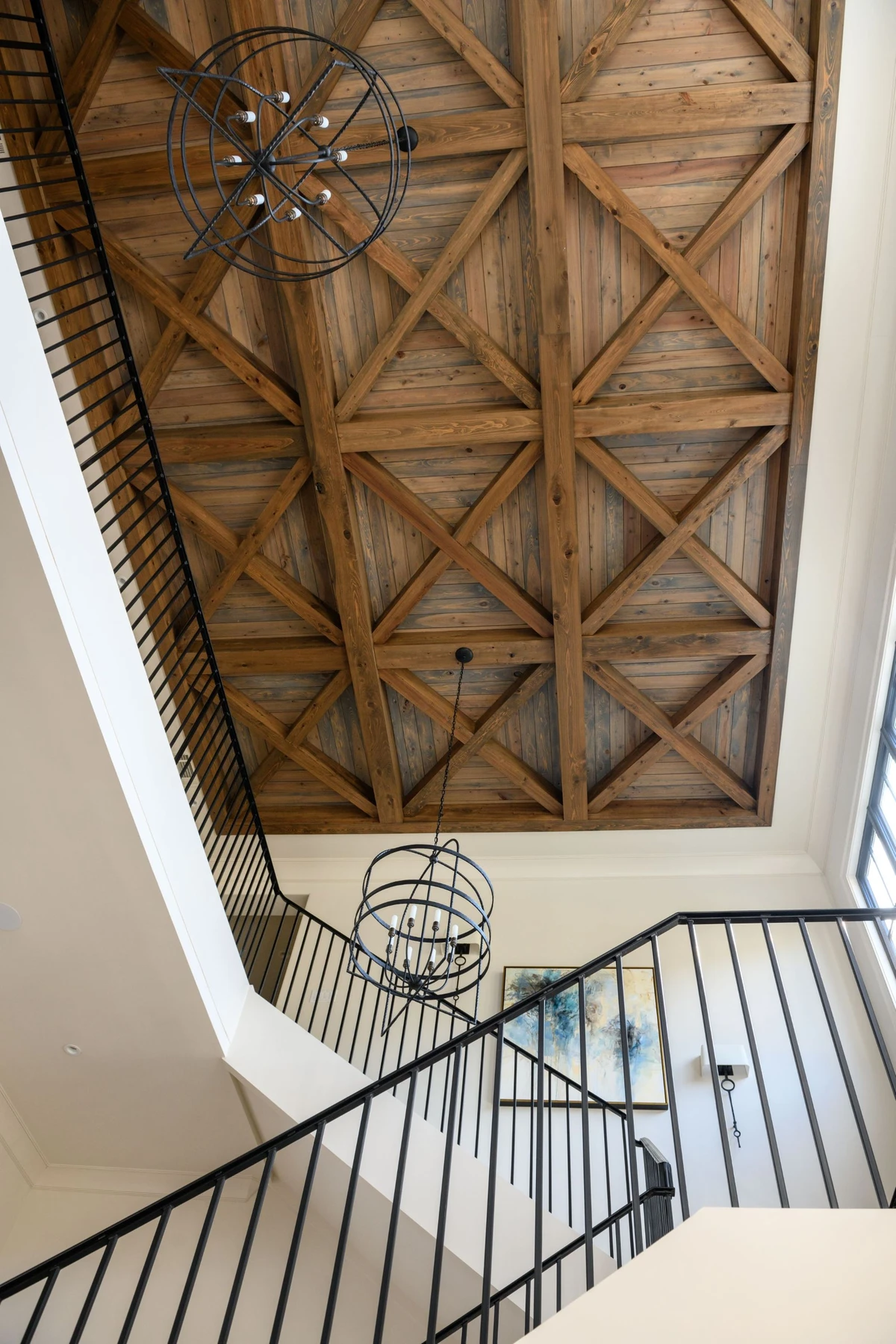 Coastal Club — staircase with geometric X-pattern coffered ceiling