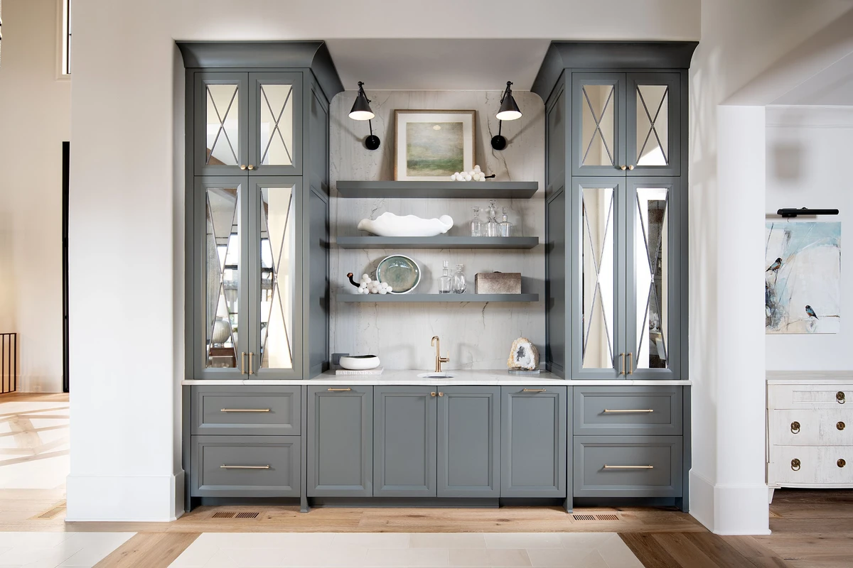 Coastal Club — bar with slate blue cabinetry and marble shelves