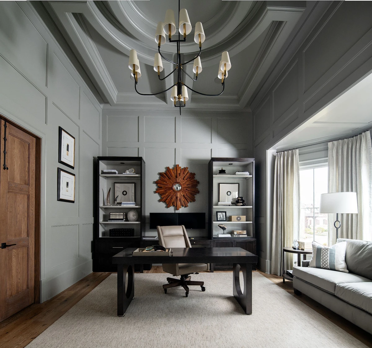 Coastal Club — home office with dark paneling and built-in bookcases