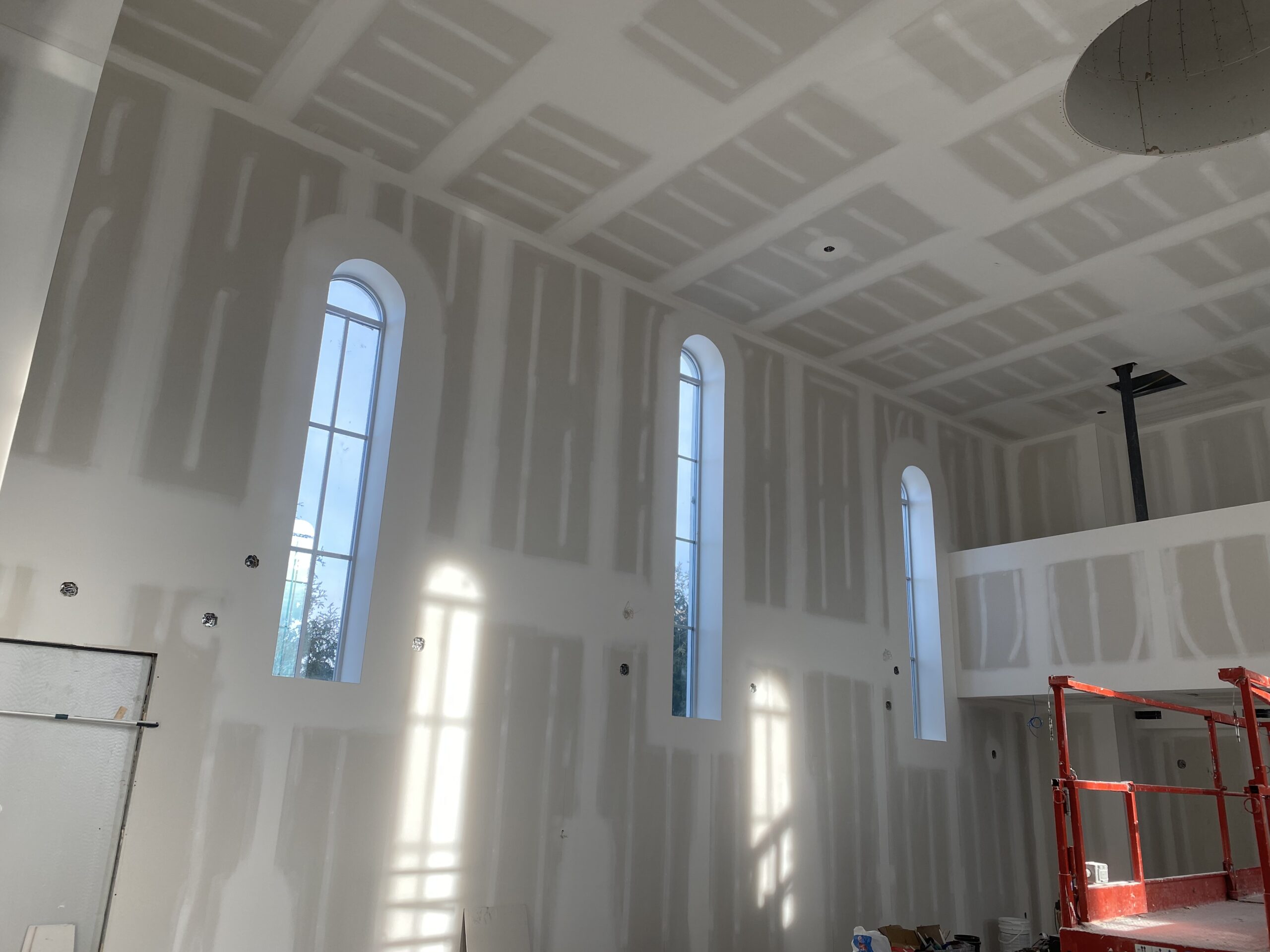 Contractor repairing drywall in Port St. Lucie home
