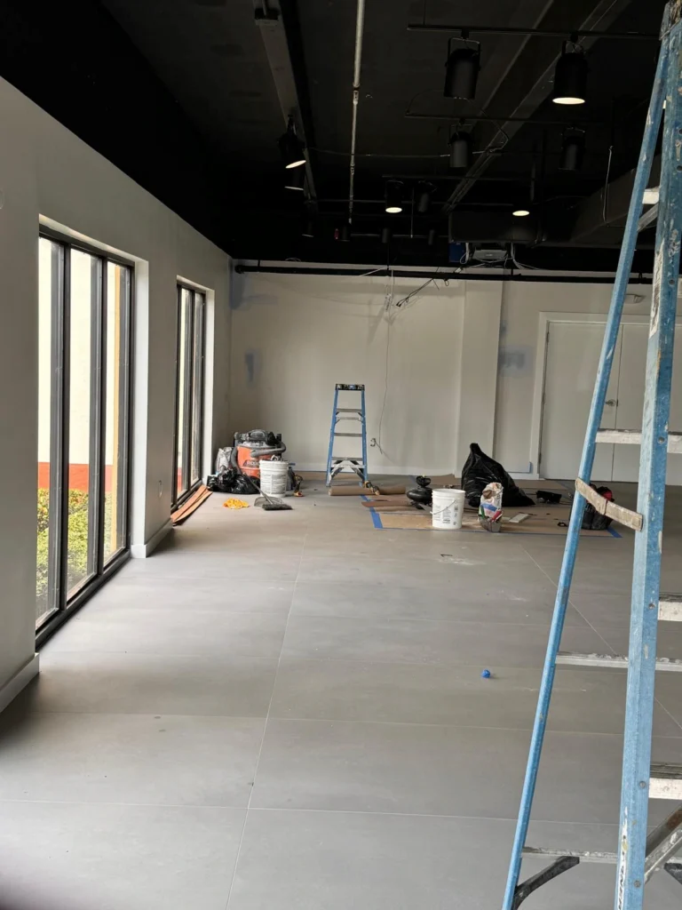 New construction homes in Stuart FL — the PSL House custom build by Nakamura Contractors at the drywall stage, with scaffolding and roughed-in plumbing